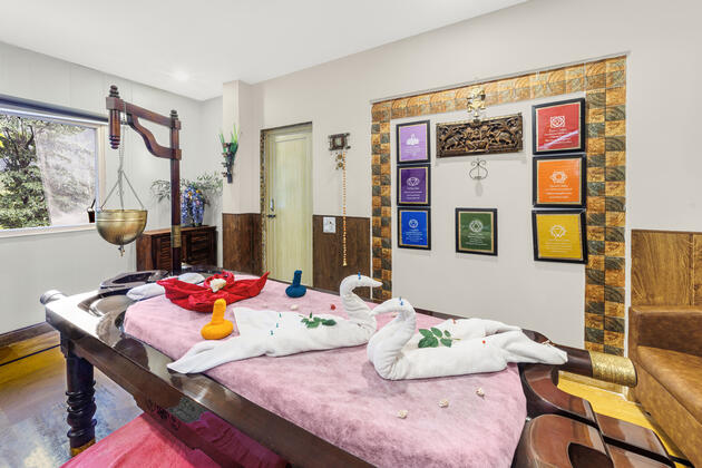 This is an image of a lady performing yoga onth ebanks of ganges in white robe